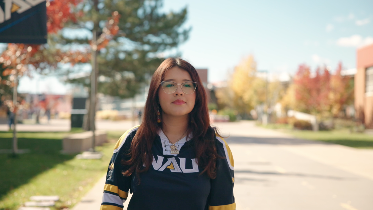 Dayana Amaya walks along pedway wearing navy blue NAU jersey